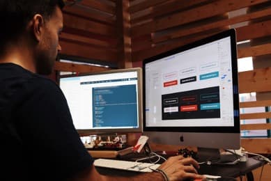 Man using a dual monitor computer system