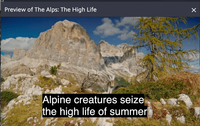 Screenshot of a nature documentary showing the Alps with closed captions